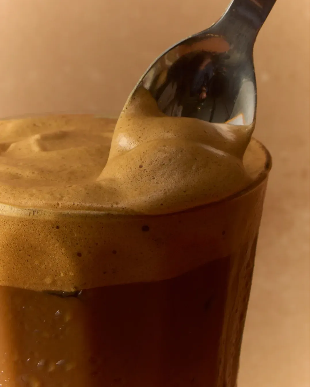 Iced coffee with Sappy syrup being stirred