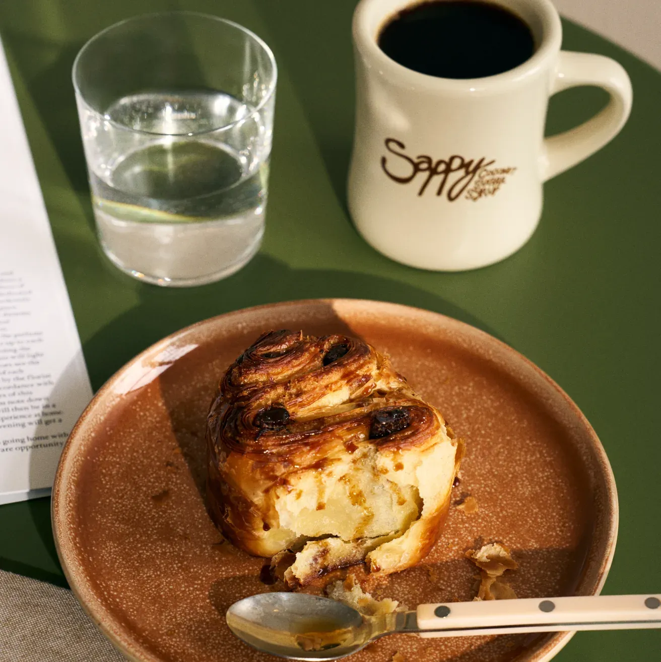 Coffee and a pastry with a Sappy mug
