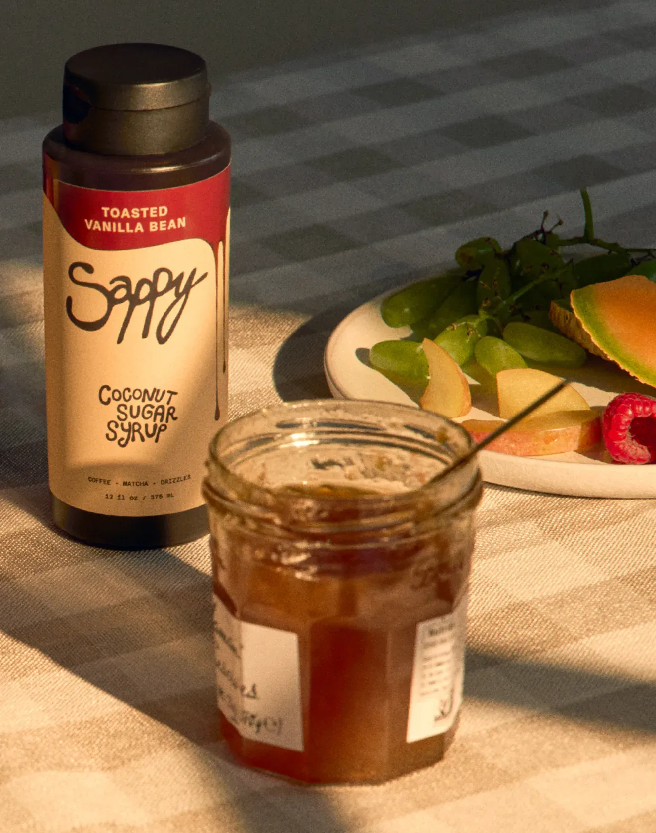 Sappy bottle and jar on a checkered cloth