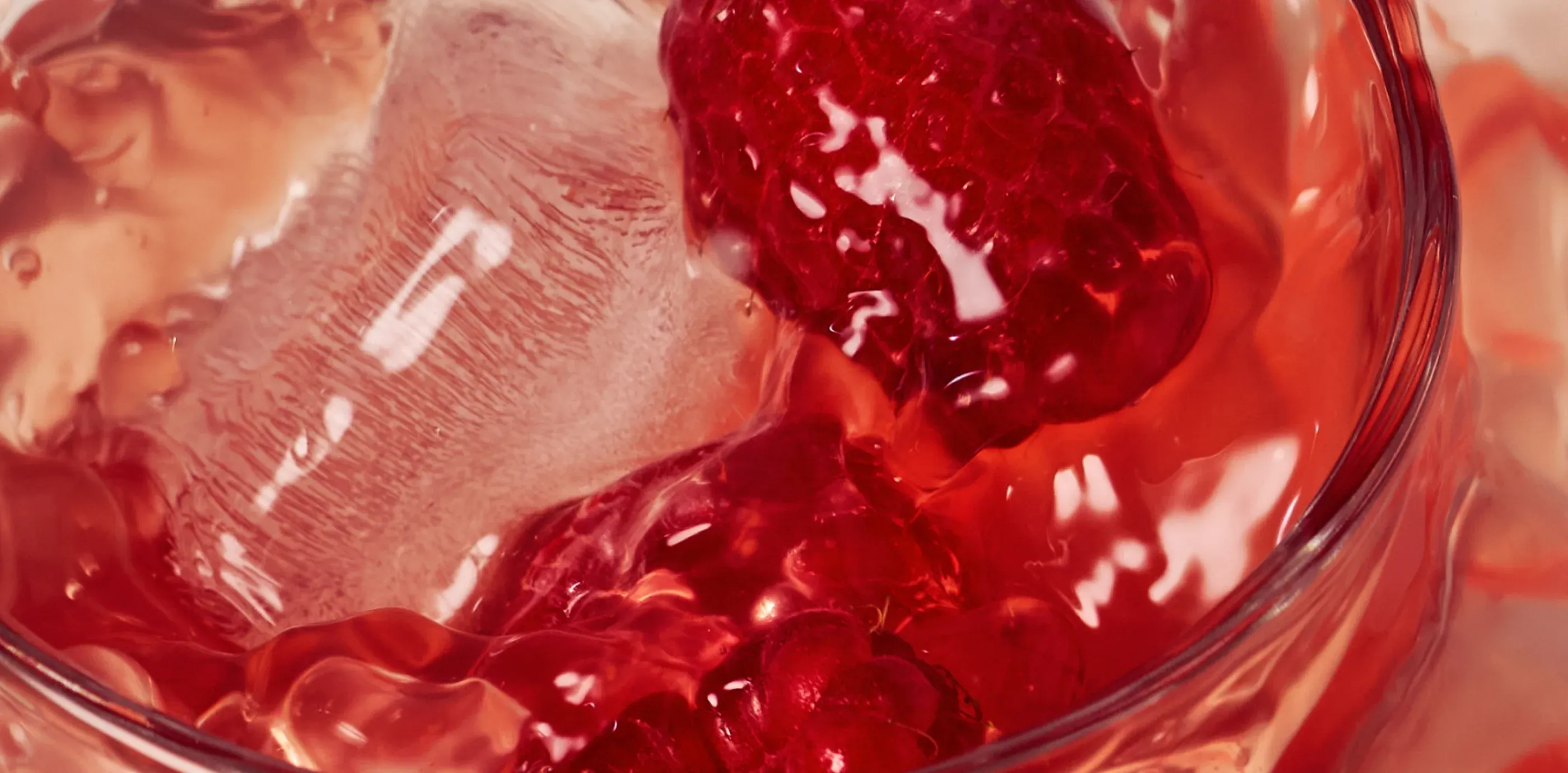 Close-up of a red raspberry drink over ice