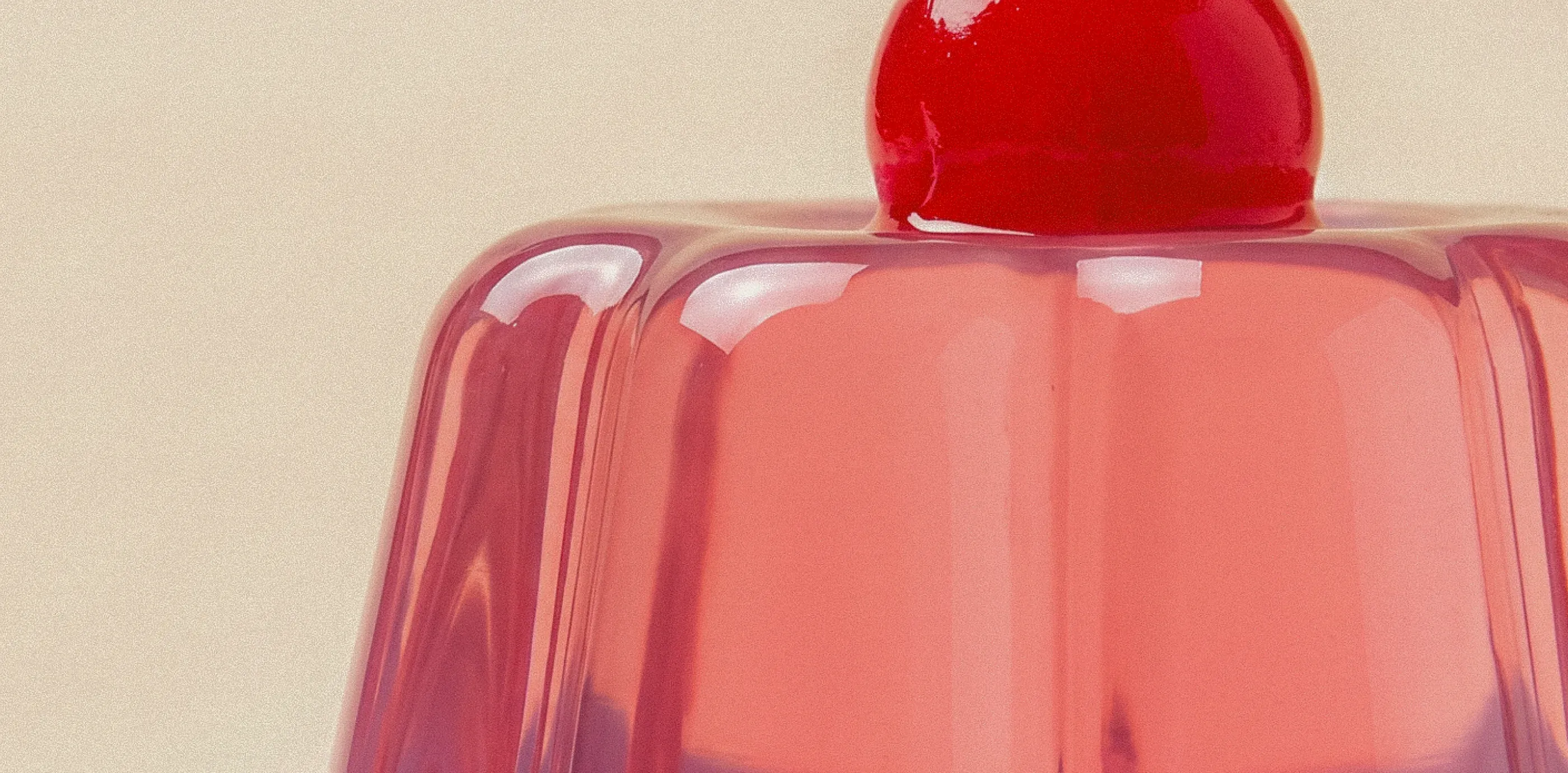 Pink gelatin dessert with a cherry on top